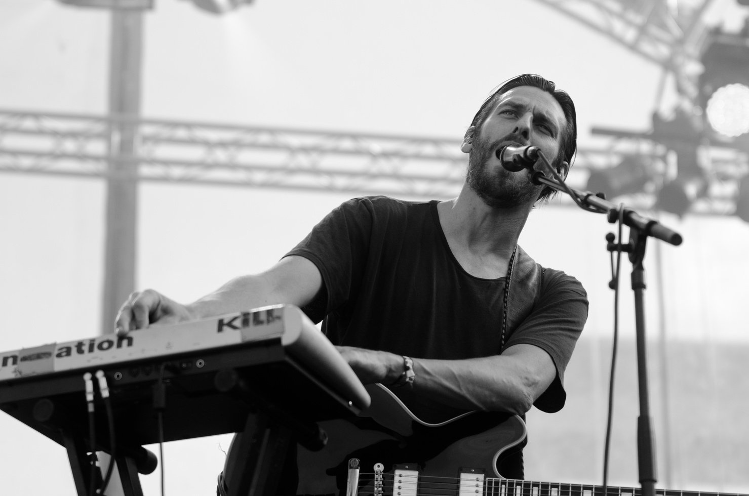 Grayscale Photo of Man Playing Electric Keyboard